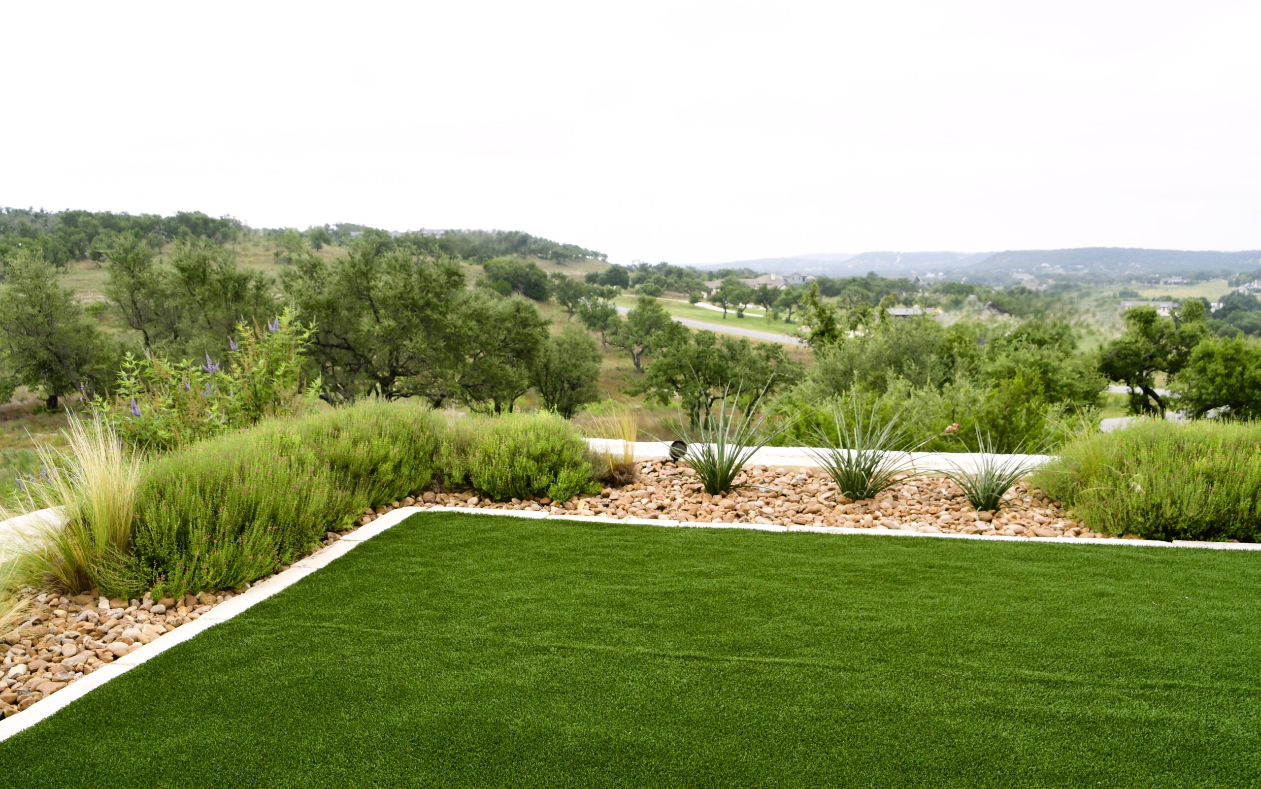 Artificial turf offers a low-maintenance alternative to traditional grass and can be especially useful in areas where natural turf struggles because of shade, rocky soil, heavy use, pets, or limited irrigation.