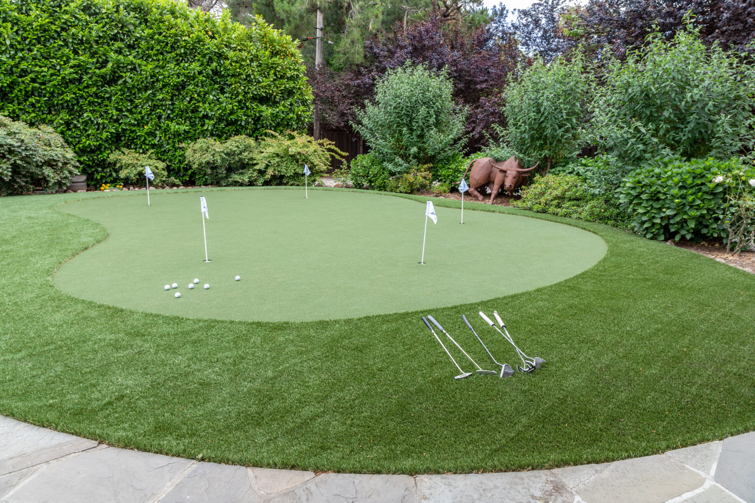 Artificial turf roll. Synthetic grass lawn laying background.